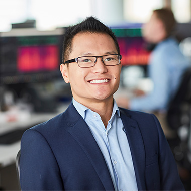 A picture of a business man with glasses smiling at the camera.