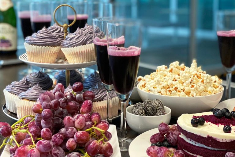 A picture of cakes, fruit and popcorn